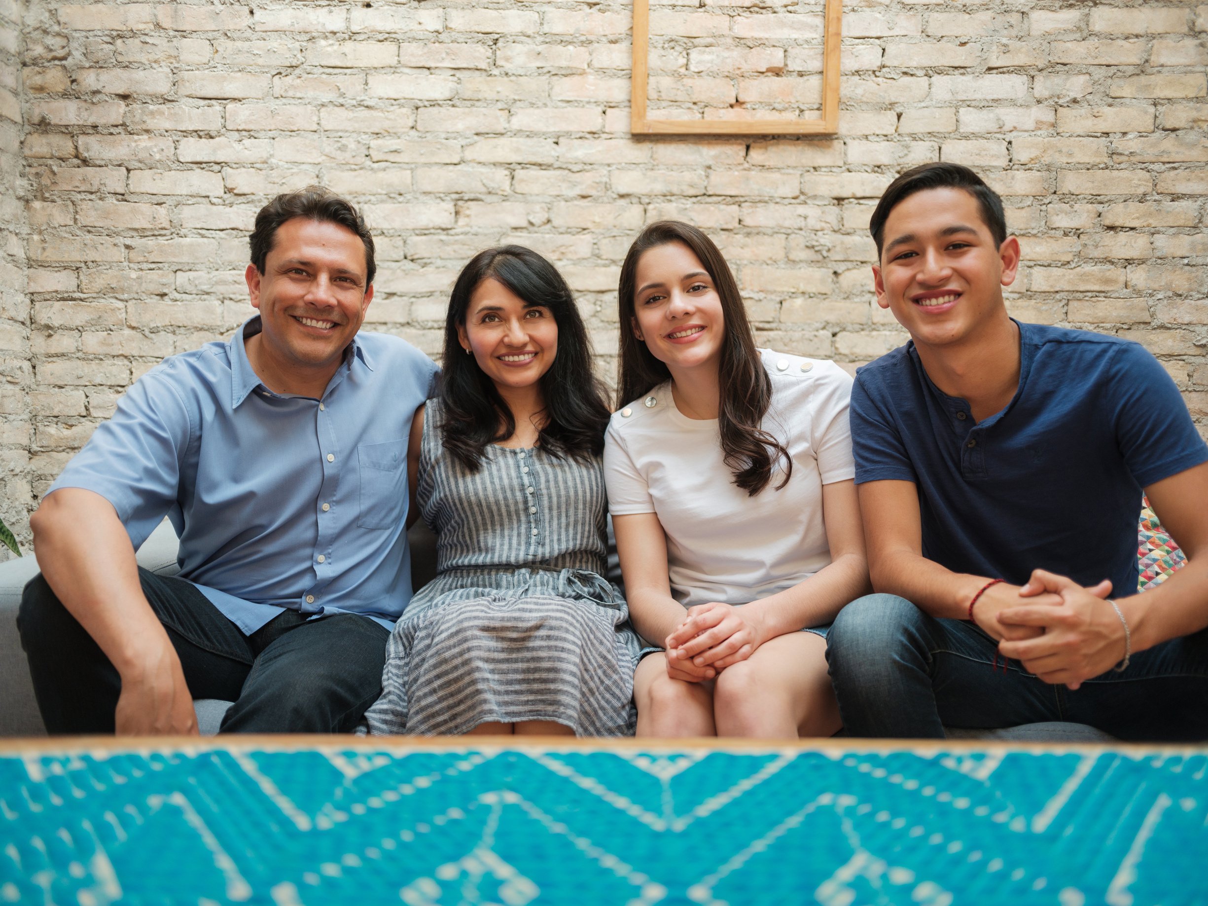 Handsome Mexican family sitting together